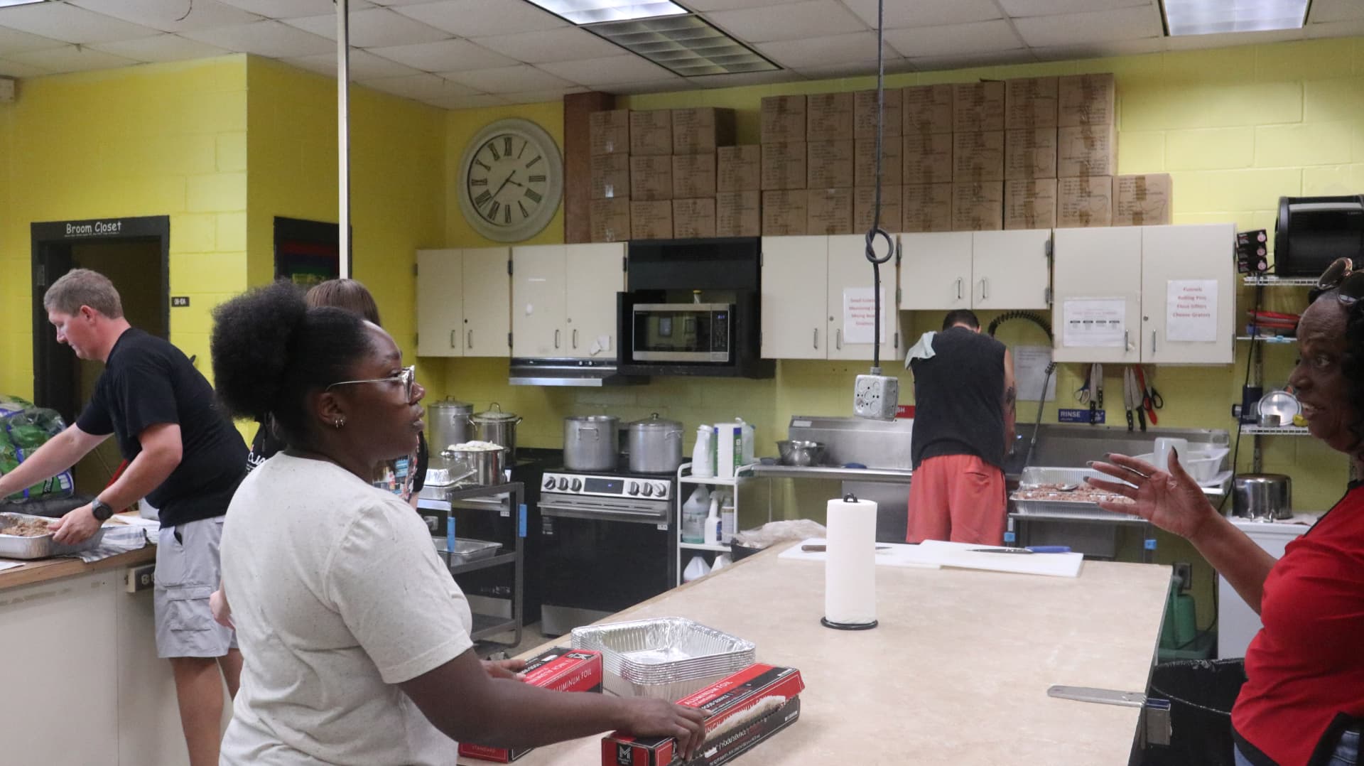 Volunteers coordinating meal prep in the kitchen during Team Mess Hall.