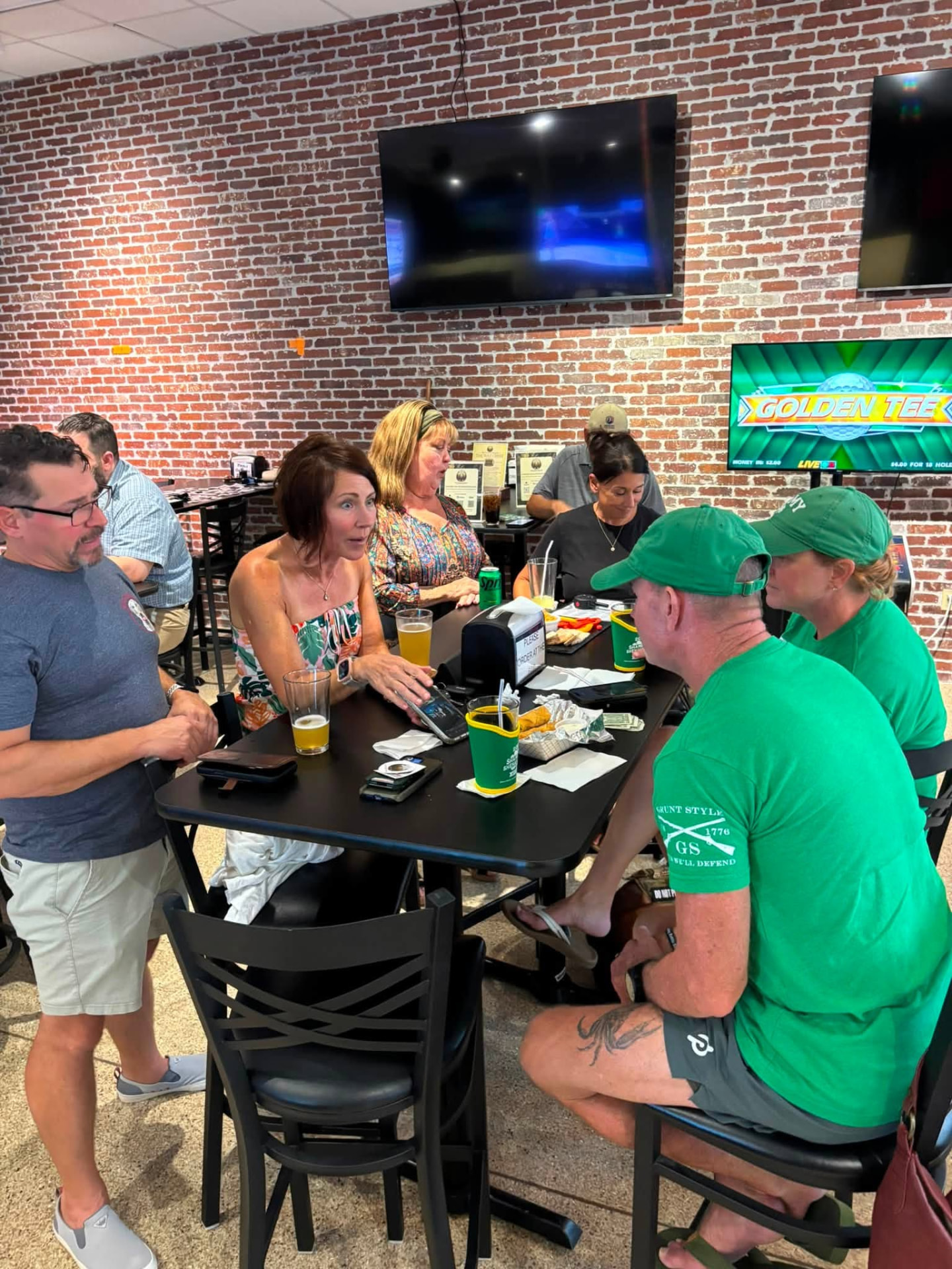 Veterans and community members talking around a table during The Muster at Over the Bridge in Yulee.
